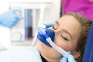 Woman under sedation while receiving dental care